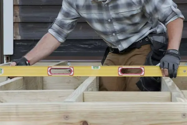 carpenter installing new wood deck