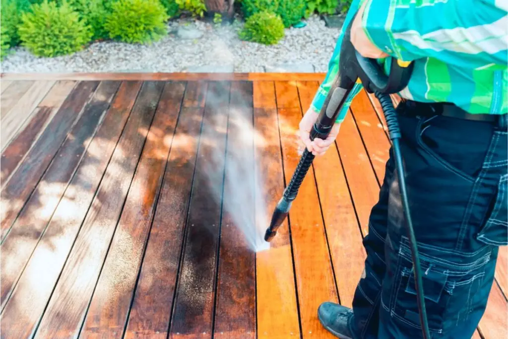 man cleaning terrace with a power washing