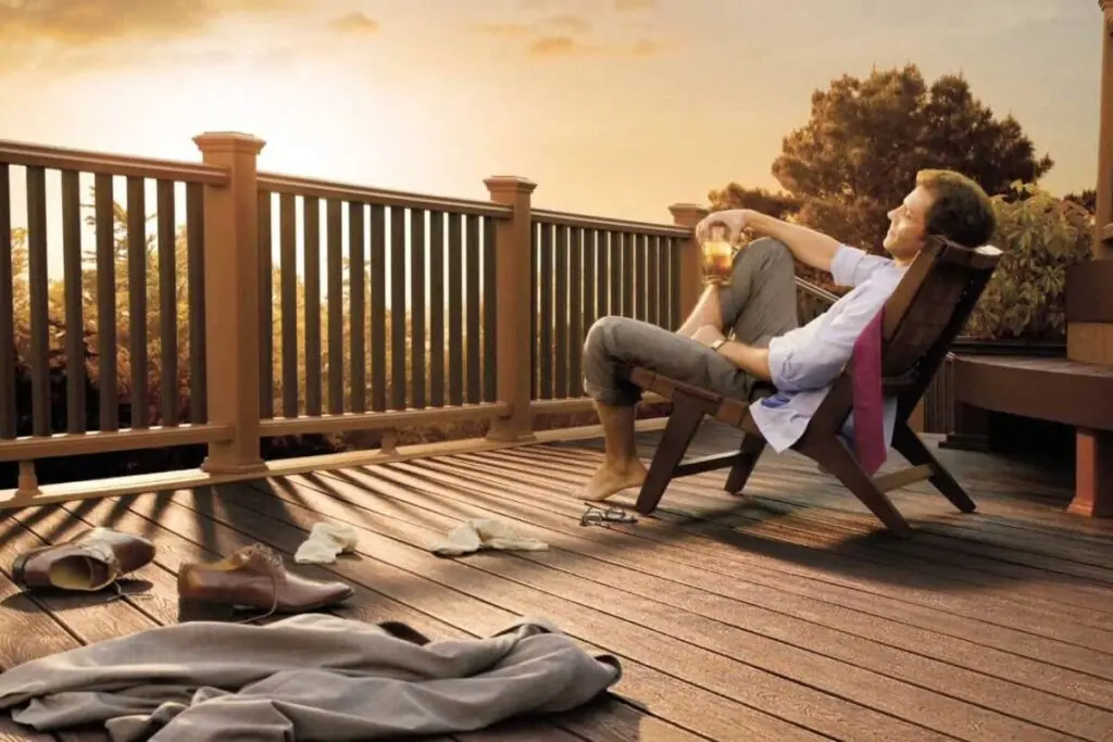 man relaxing on his new outdoor wooden deck while drinking