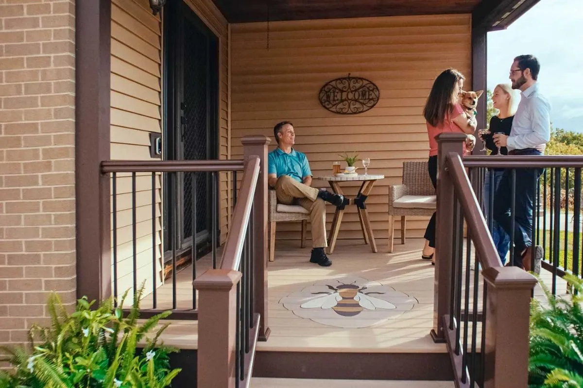 group of friends drinking wine on deck porch