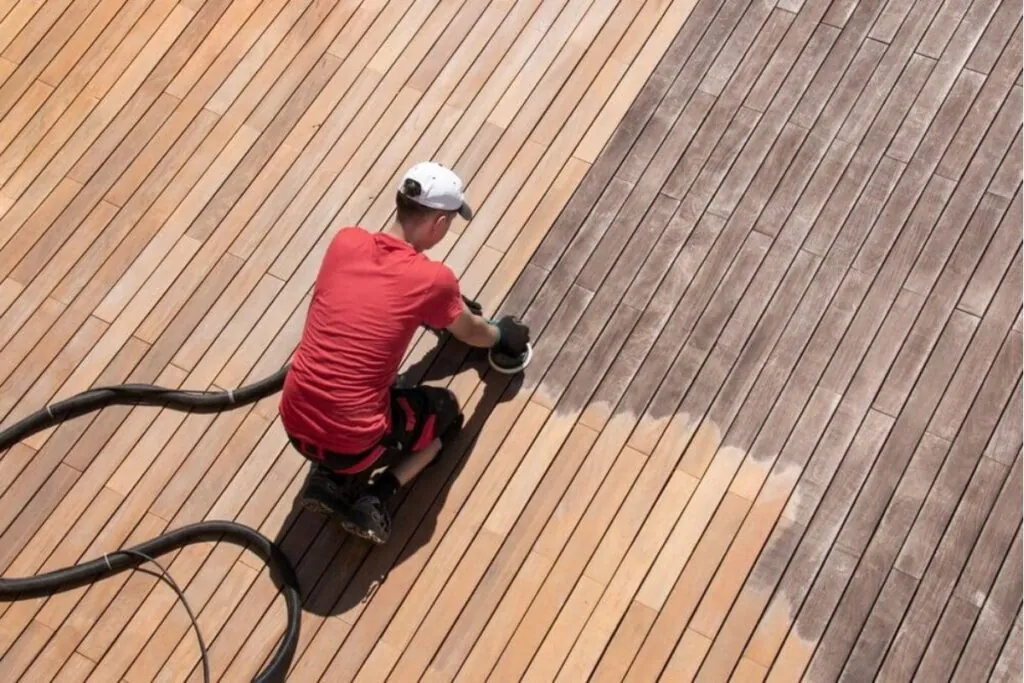 professional deck contractors working on deck maintenance using sander